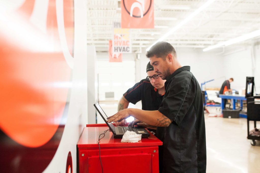 Diesel Mechanics looking at computer