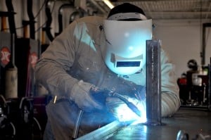 A welder is welding in a lab