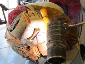a welder using stick welding
